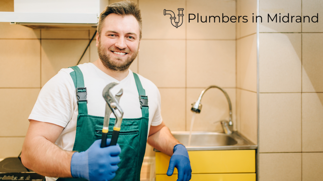 Plumber smiling standing in front of a kitchen sink with running water